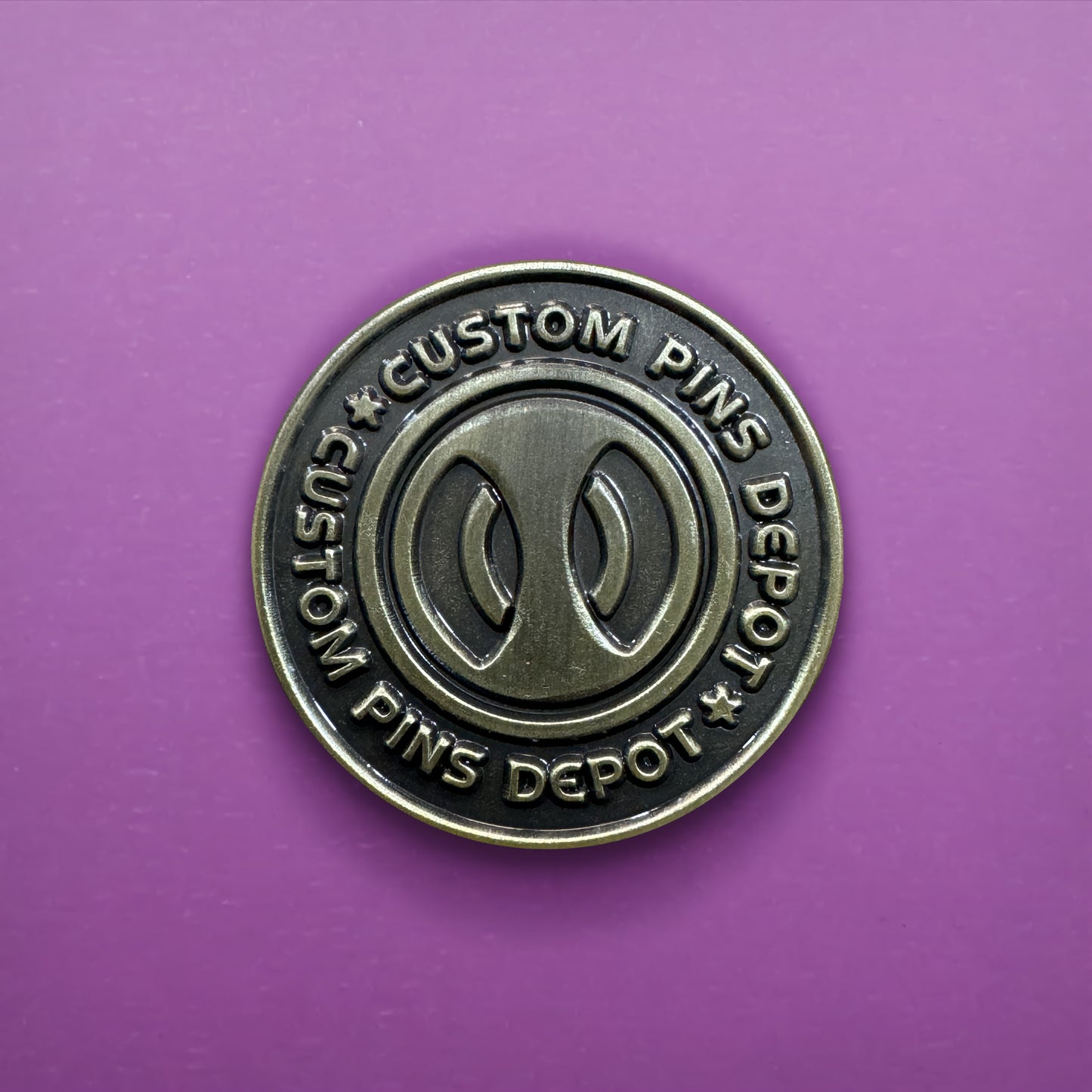 Gunmetal Finish Logo Coin on Purple Background