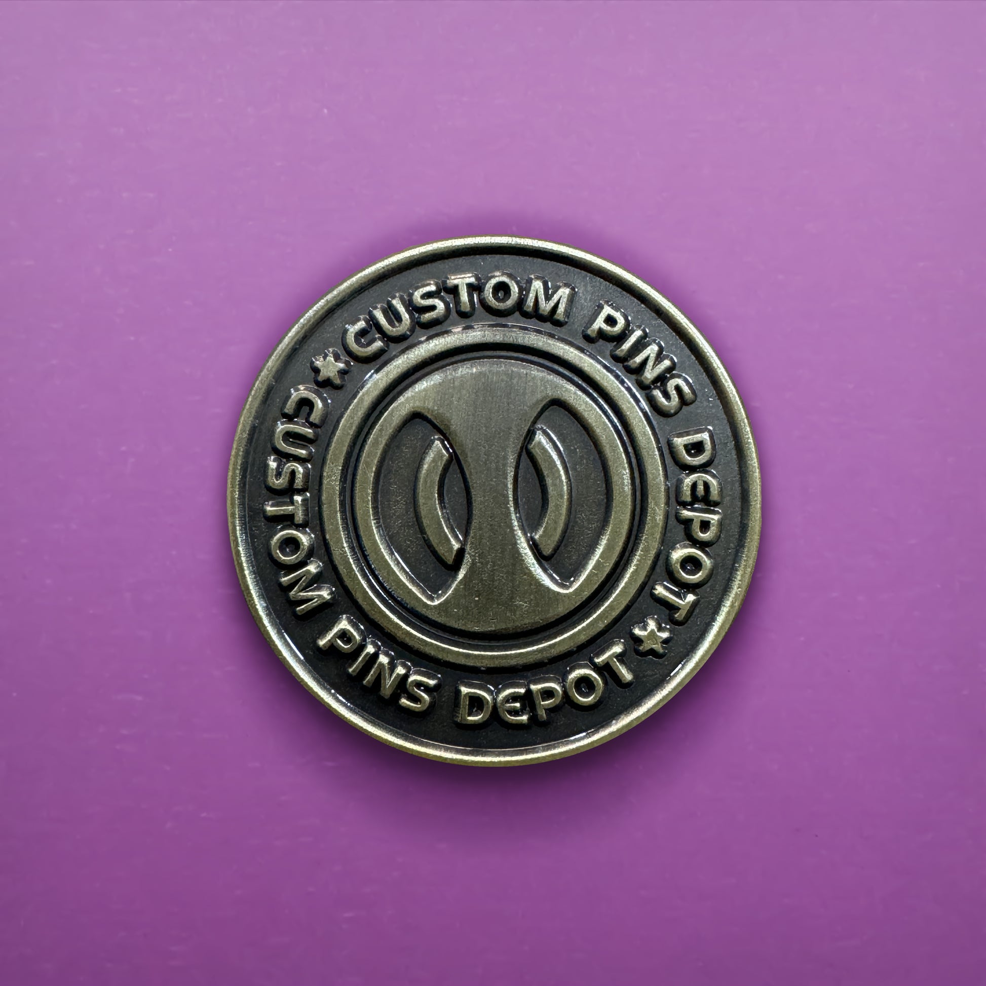 Gunmetal Finish Logo Coin on Purple Background